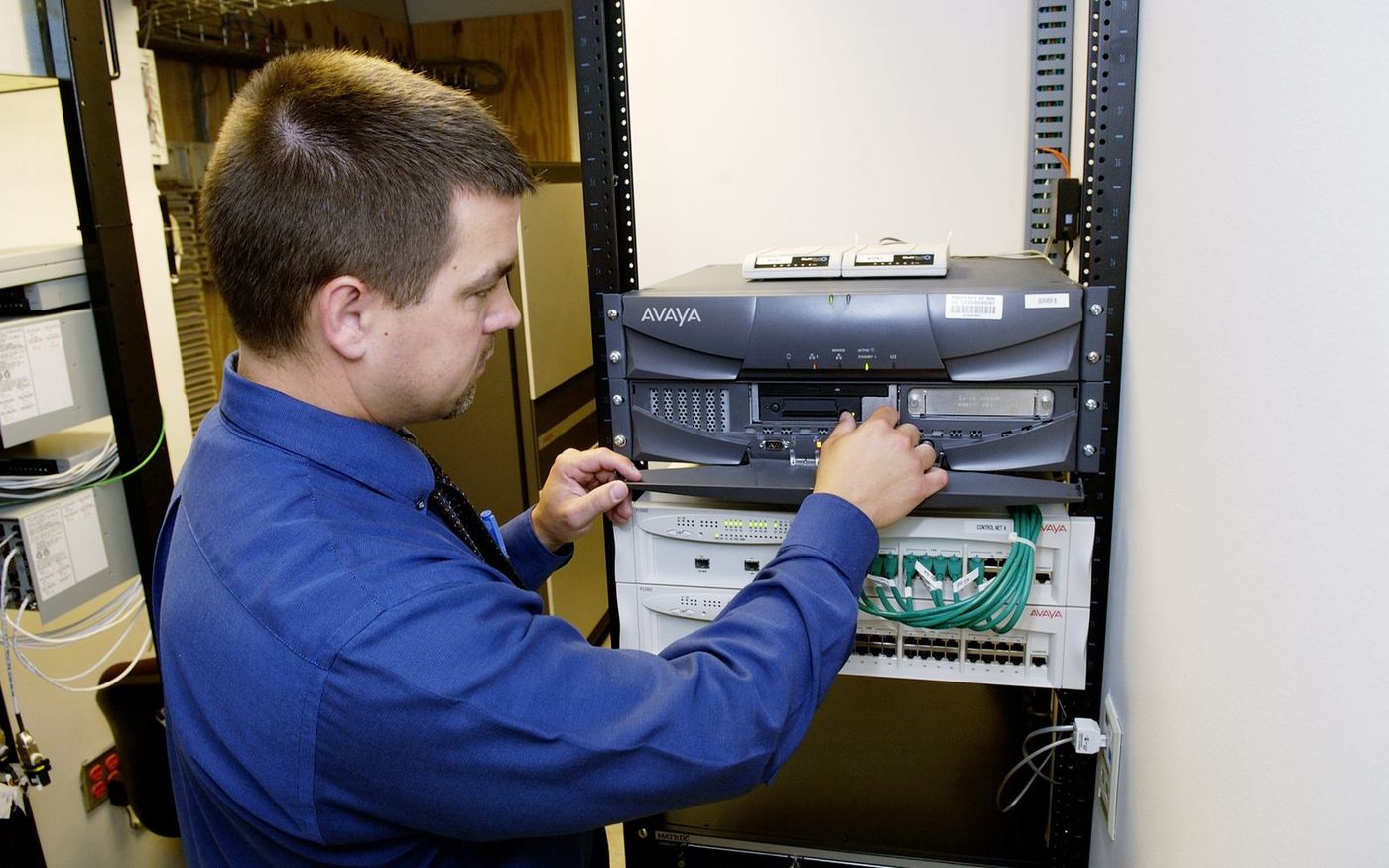 IT technician working on network server equipment